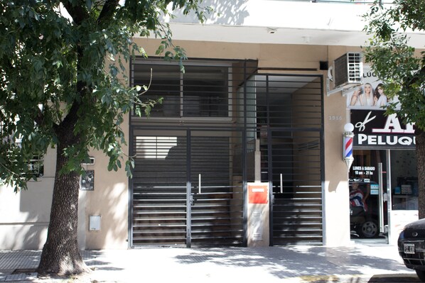 A closed metal shutter door with a sign above it.