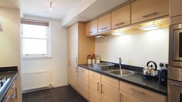 Apartment, 2 Bedrooms, Non Smoking (108F) | Private kitchen | Full-size fridge, microwave, oven, stovetop