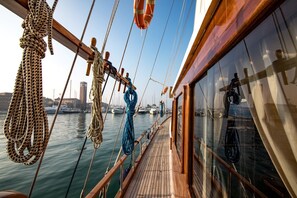 A wooden deck with ropes and a lifebuoy on a ship. - Venezia Boat San Marco (Venice)