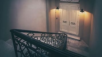 A staircase with ornate black railings leading to a landing.