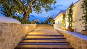 A stone staircase leading to a building with a white exterior, surrounded by plants and trees. - Agroturismo Can Toni Xumeu - Only Adults (Santa Eulalia del Rio)