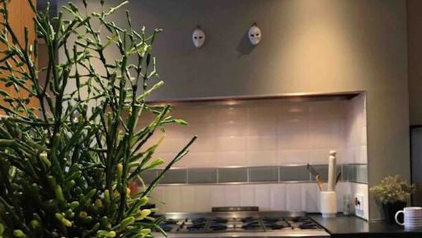 A modern kitchen with a gas stove, oven, and stainless steel sink. - Vollie House (Thornhill)