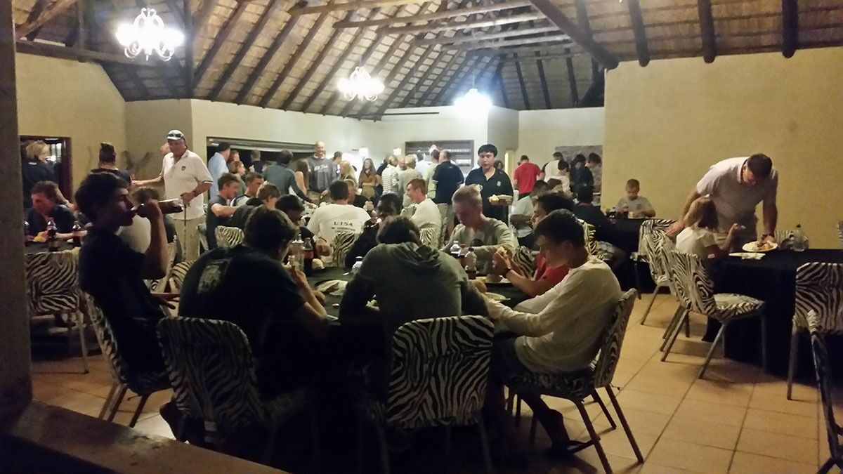 A crowded indoor dining area with zebra-striped chairs and tables.