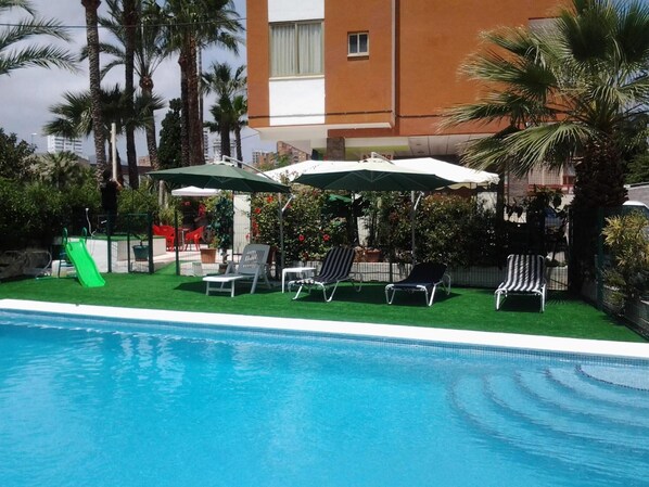 Outdoor pool, open 10:00 AM to 10:00 PM, pool loungers