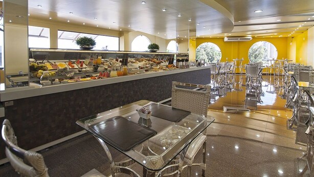 A buffet area with a variety of food items, a counter, and seating arrangements. - JP Palace Hotel (Franca)