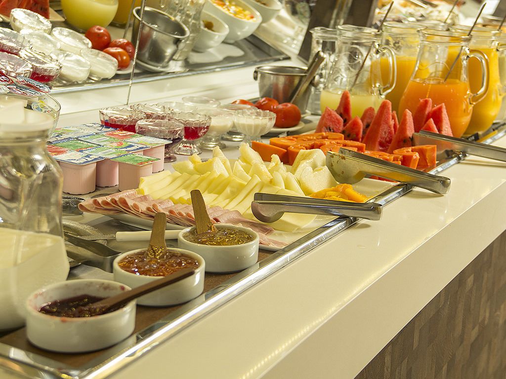 A buffet with various food items and condiments.