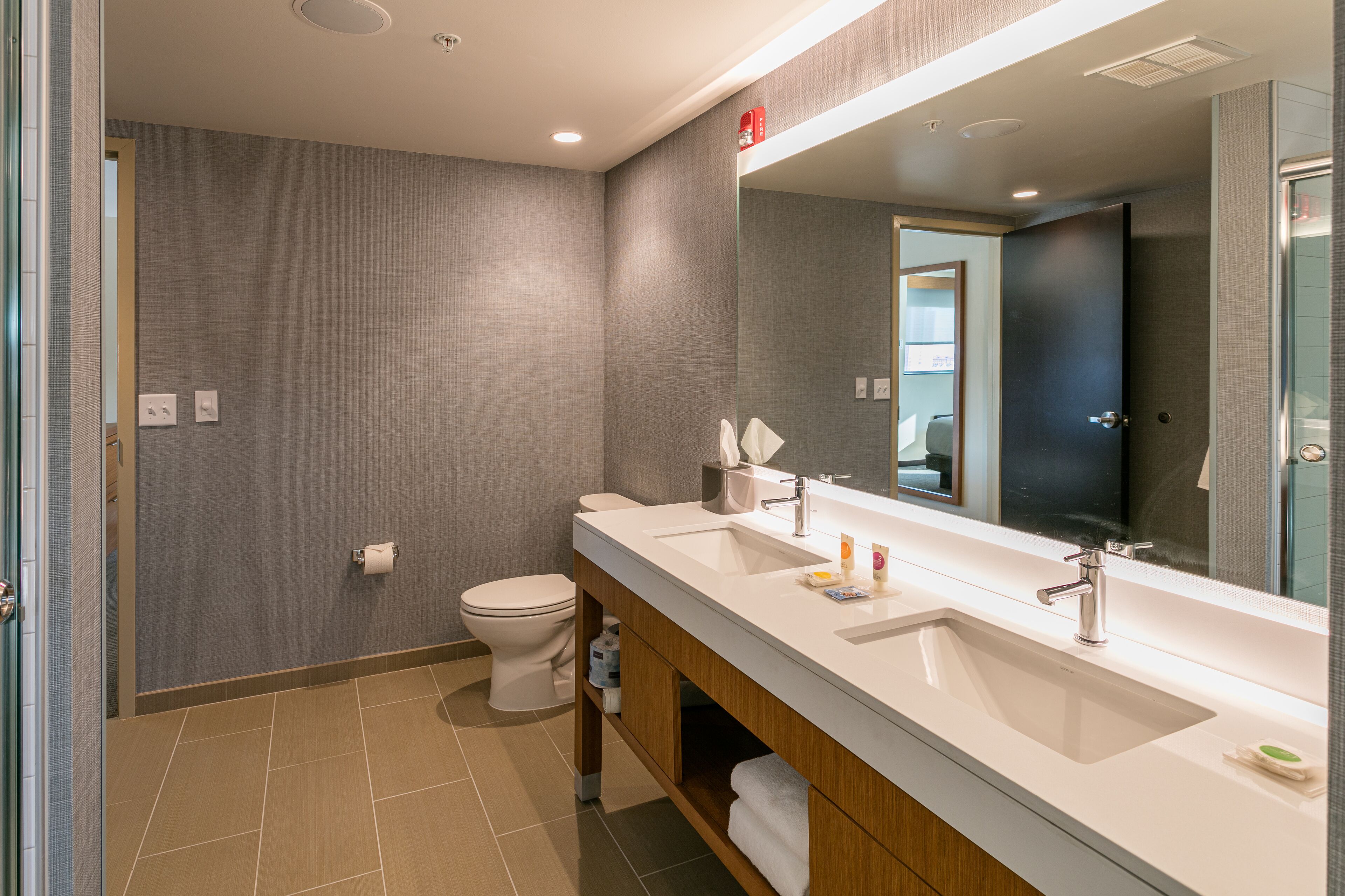 designer toiletries, hair dryer, towels