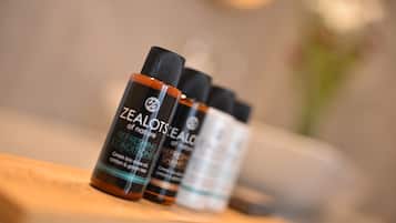 Three bottles of Zealots Refreshing Conditioner on a wooden surface.