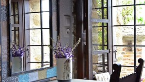 A rustic interior with a stone wall, a wooden table, and a chair. - Fyloma (South Pelion)