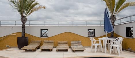 Piscine extérieure, parasols de plage, chaises longues