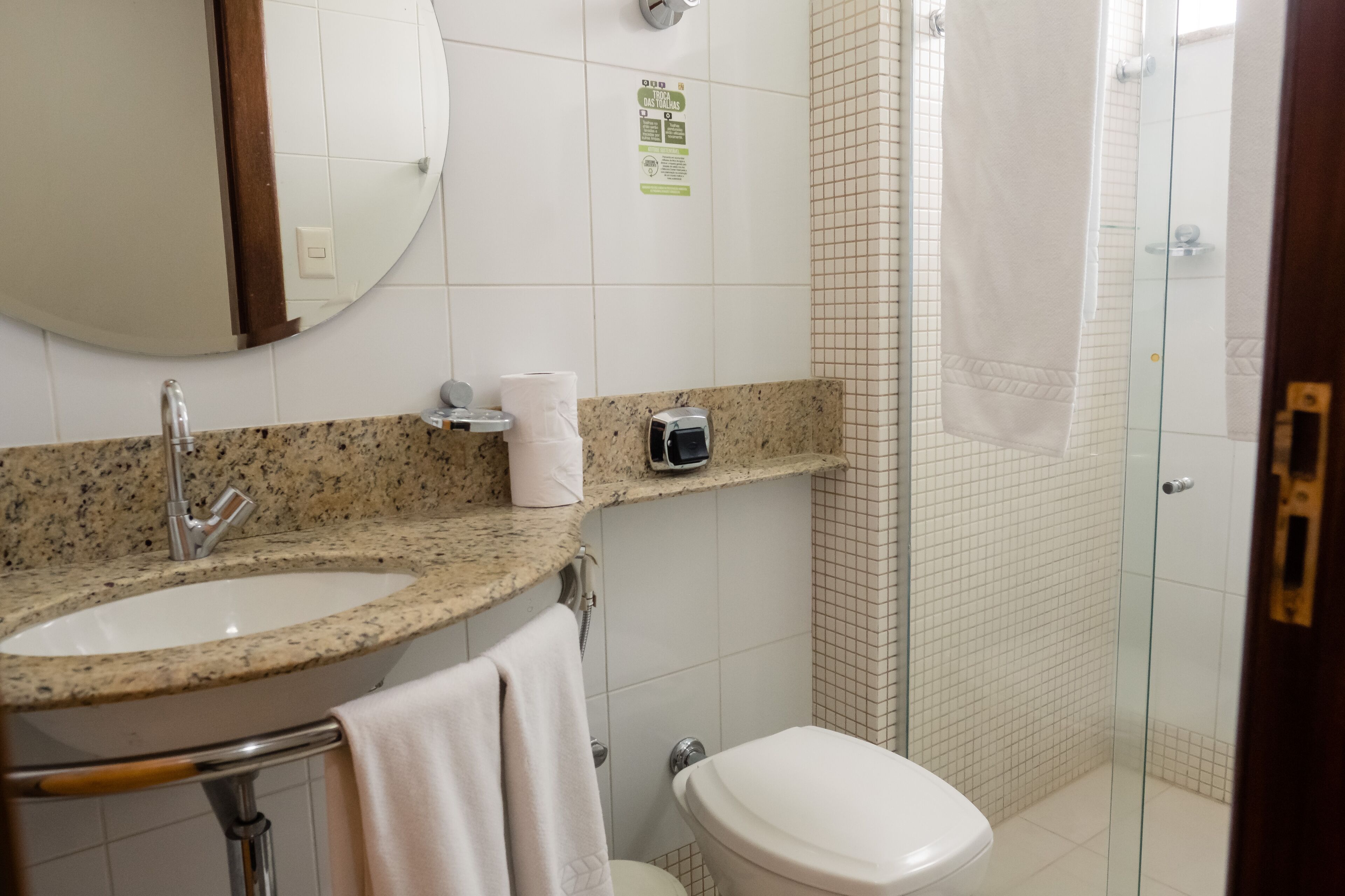A bathroom with two sinks, a toilet, a shower, and a mirror.