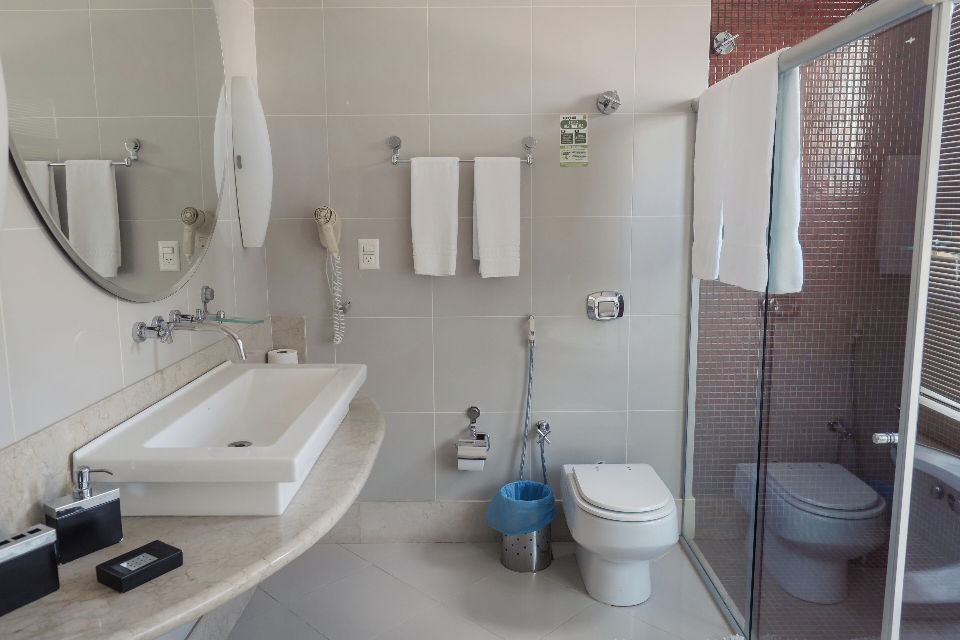 A modern bathroom with a sink, toilet, and shower area.