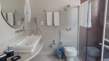A modern bathroom with a sink, toilet, and shower area.