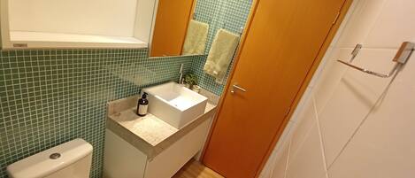 Un baño con inodoro, lavabo y espejo.