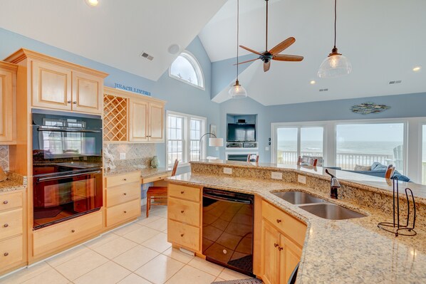 Enjoy cooking in this well-equipped kitchen with a large island, double oven, and ample counter space.