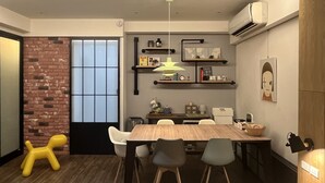 A modern dining area with a wooden table, grey chairs, and a yellow toy horse.
