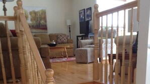 A wooden staircase with a railing leading to a living room area. - Bay of Fundy ,Cobequid Bay, Steps to  the beach in  the Cliffs of Fundy Geopark (Economy)