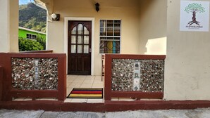 Uma entrada de prédio com porta de madeira, uma pequena janela e uma placa para Snow Wellness.