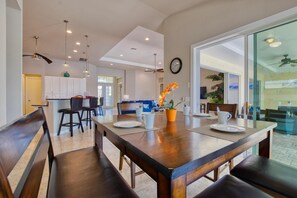 Enjoy meals with family and friends in this stylish dining area, featuring a large table and comfortable seating for four.