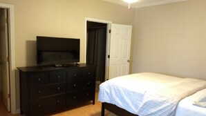 A bedroom with a bed, a dresser, and a television. - Great Apartment in Historic Downtown Columbus. (Columbus)