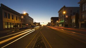 A street view at dusk with illuminated buildings and light trails from vehicles. - Great Apartment in Historic Downtown Columbus. (Columbus)