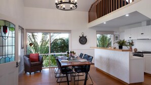 A modern kitchen with white cabinets, a wooden countertop, and a built-in stove. - Aggies Way - dog friendly with  panoramic views (Daylesford)