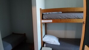 A bunk bed with a sign warning about the height of the bed.