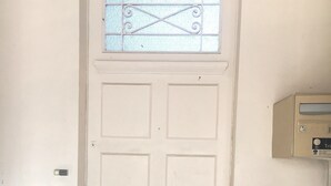 A white door with a small window and a mail slot. - La Poste (Hontanx)