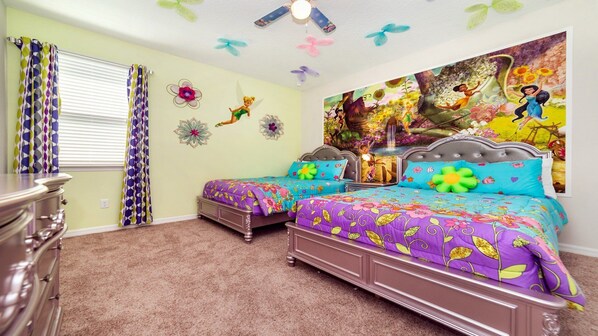 A bedroom with two beds, a dresser, and a large floral painting on the wall.