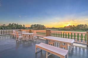 Enjoy dining or socializing in this serene outdoor space with a clear view of the surrounding landscape.