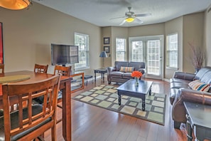 Relax in this inviting living room with a comfortable sofa, dining table, and flat-screen TV.