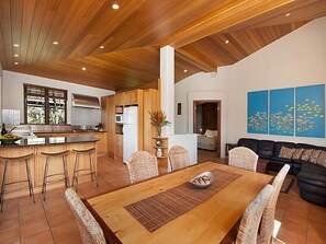 Enjoy meals in the kitchen area, dine at the wooden table, or relax on the black leather sofa.
