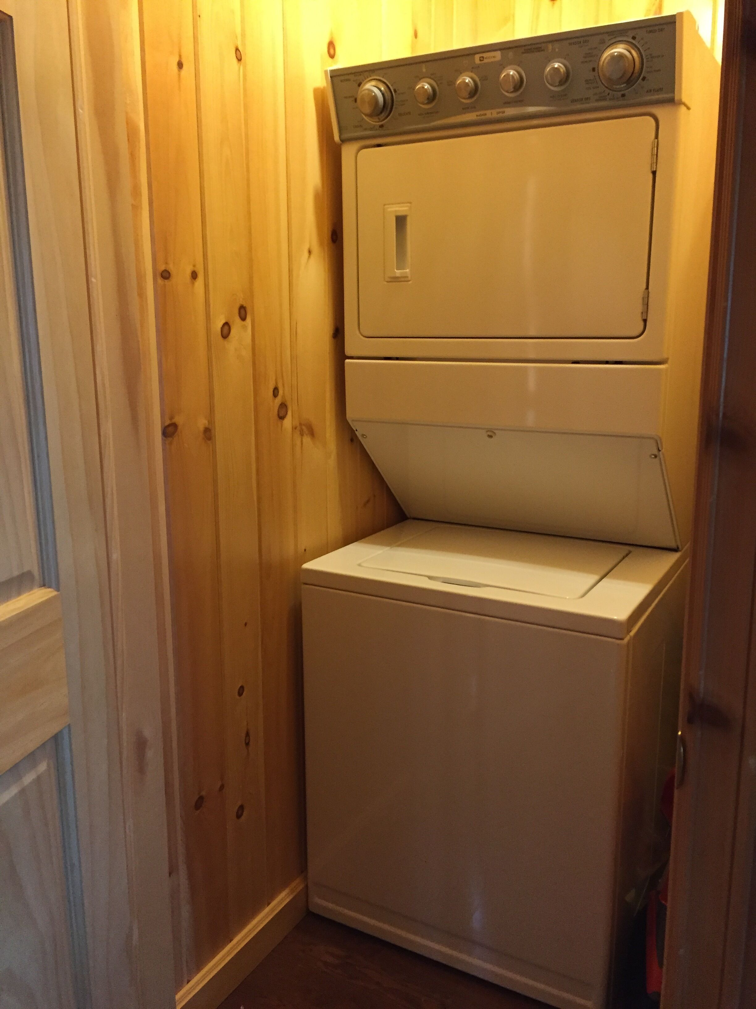 A compact, white, two-door washer and dryer unit with a control panel on top.