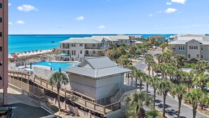 A resort with a pool, beachfront view, and multiple buildings. - Jetty view at Jetty East! One free beach chair set up daily. (Destin)