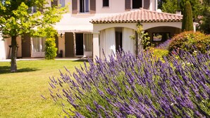 A two-story house with a tiled roof, a covered porch, and a well-maintained lawn. - Prestige 5 star villa  (Saint-Rémy-de-Provence)