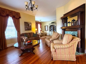 Cozy living room with a fireplace, sofa, and armchair, perfect for relaxing.