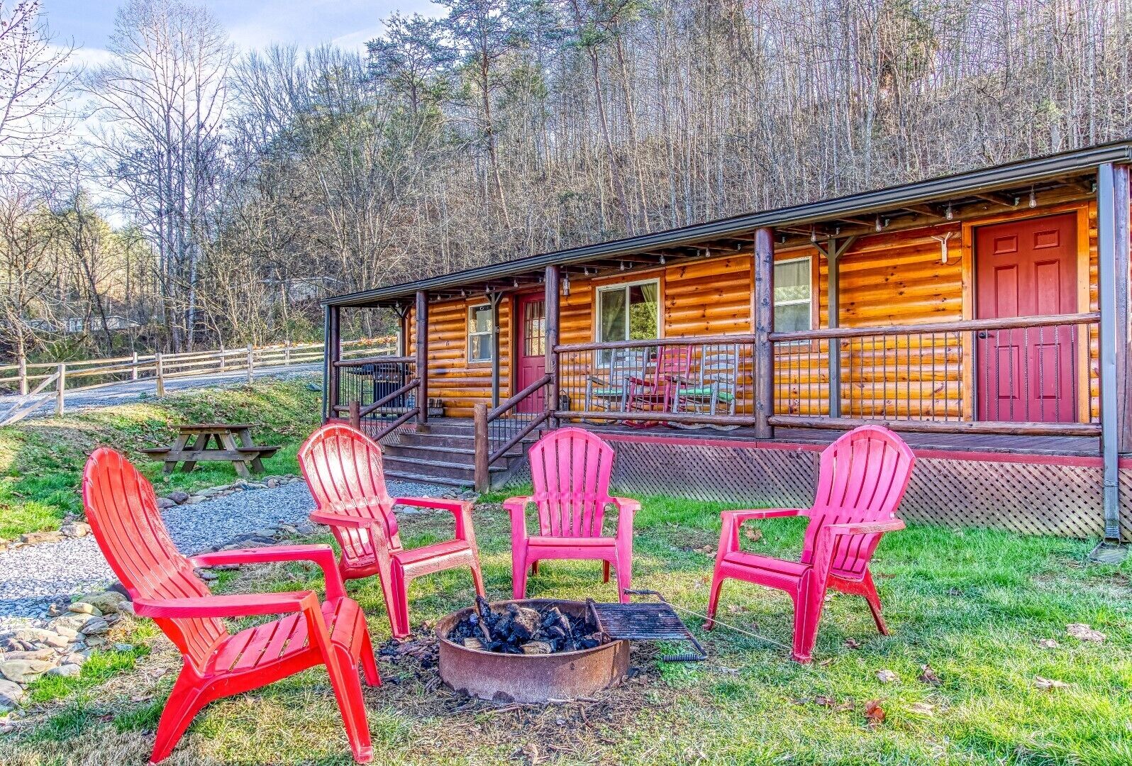 A log cabin with a porch and outdoor seating area.