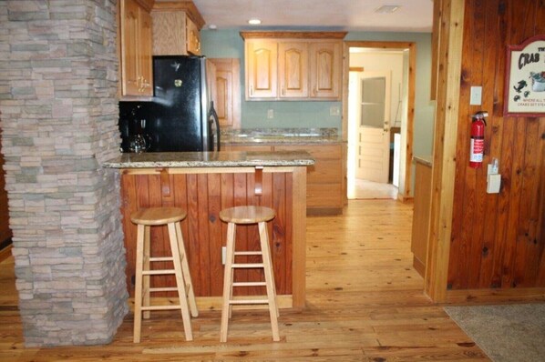 Enjoy cooking in this well-equipped kitchen with a spacious counter and comfortable stools.