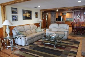 Cozy living space with leather sofas, coffee table, and dining area.