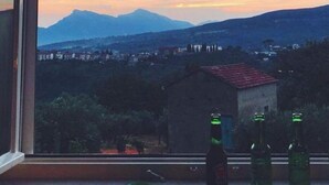 A view from a window overlooking a mountainous landscape with a small building and trees in the foreground. - La Terrazza di Laurino (Laurino)