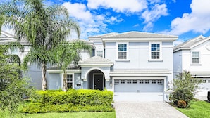 A two-story house with a garage, a front entrance, and a well-maintained lawn. - Harry Potter, Mickey & Space Rooms + Theater! (Davenport)