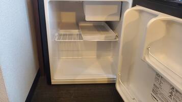 An open refrigerator with a shelf and a door handle.