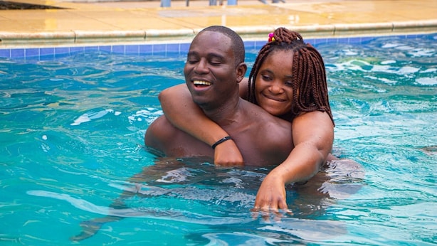 A man and a woman in a swimming pool. - NP Plaza Hotel (Akosombo)