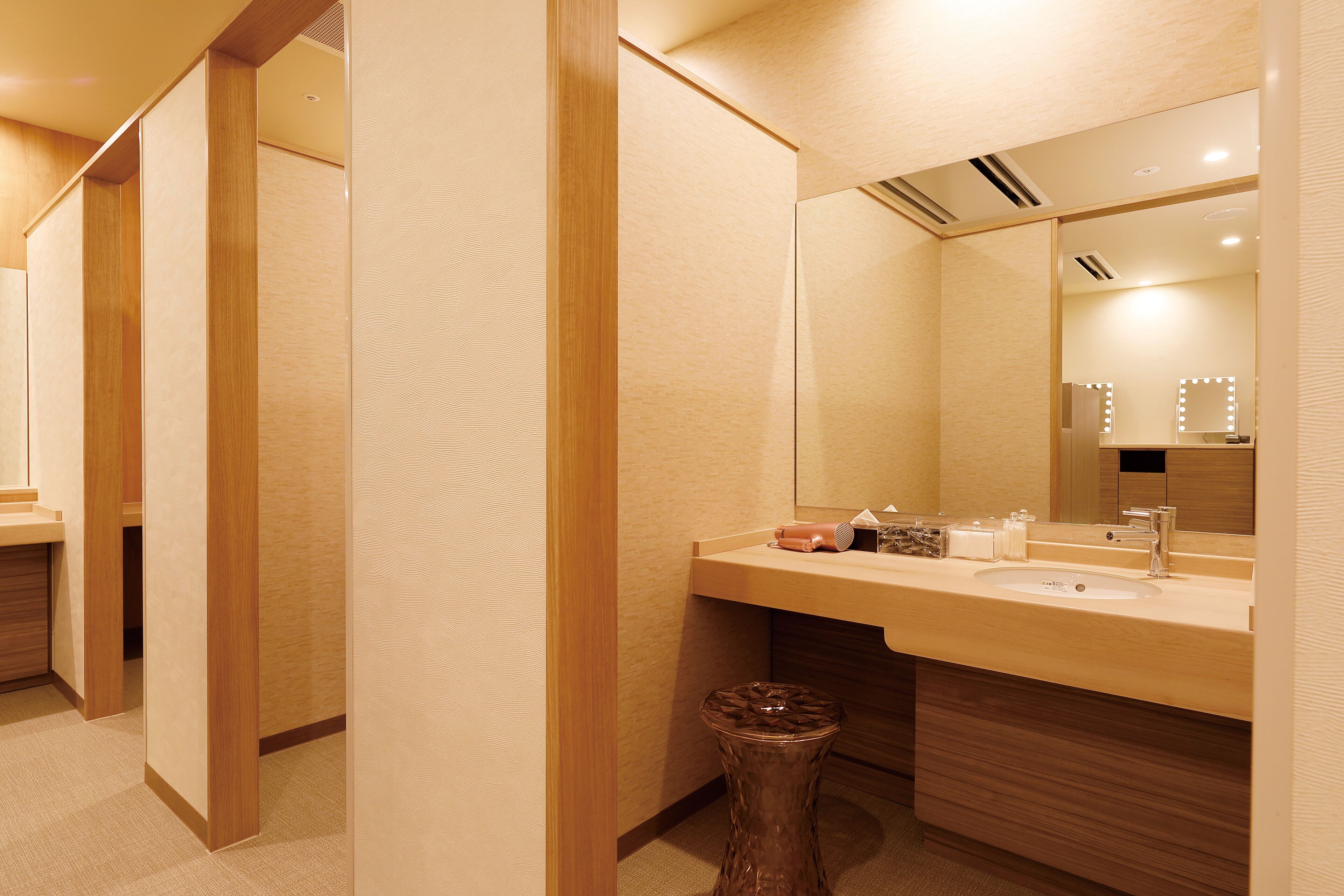 A modern bathroom with a large mirror, vanity, and a sink.