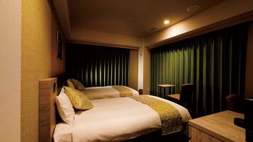 A hotel room with two beds, a desk, and a chair.