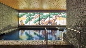 A serene indoor pool area with a wooden ceiling, stone walls, and a stained glass window depicting a landscape. - Daiwa Roynet Hotel Nara Natural Hot Springs (Nara)