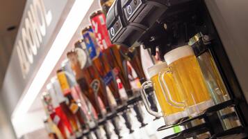 A bar with a variety of beer taps and mugs.