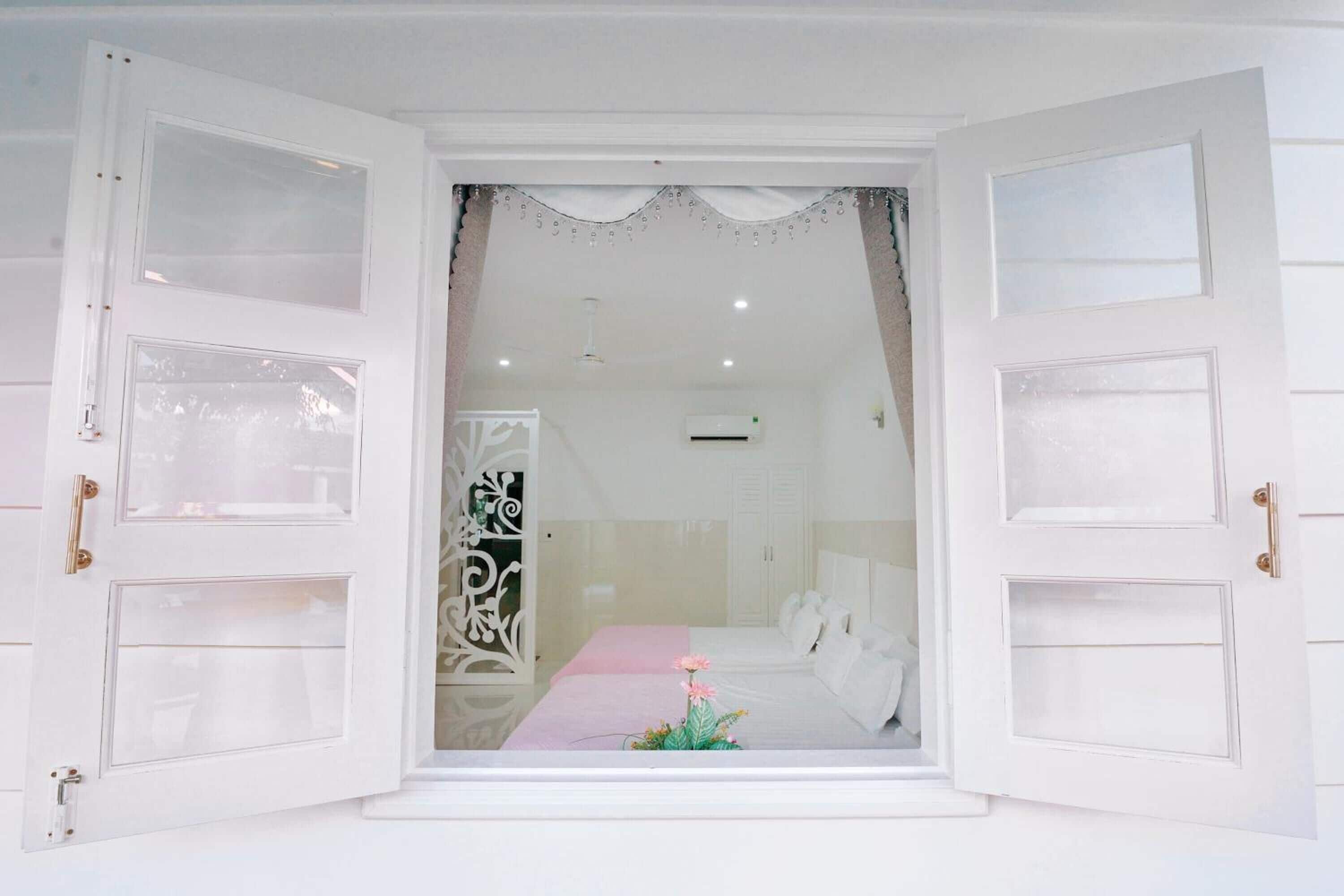 A room with a bed, a nightstand, and a decorative item on the bed.