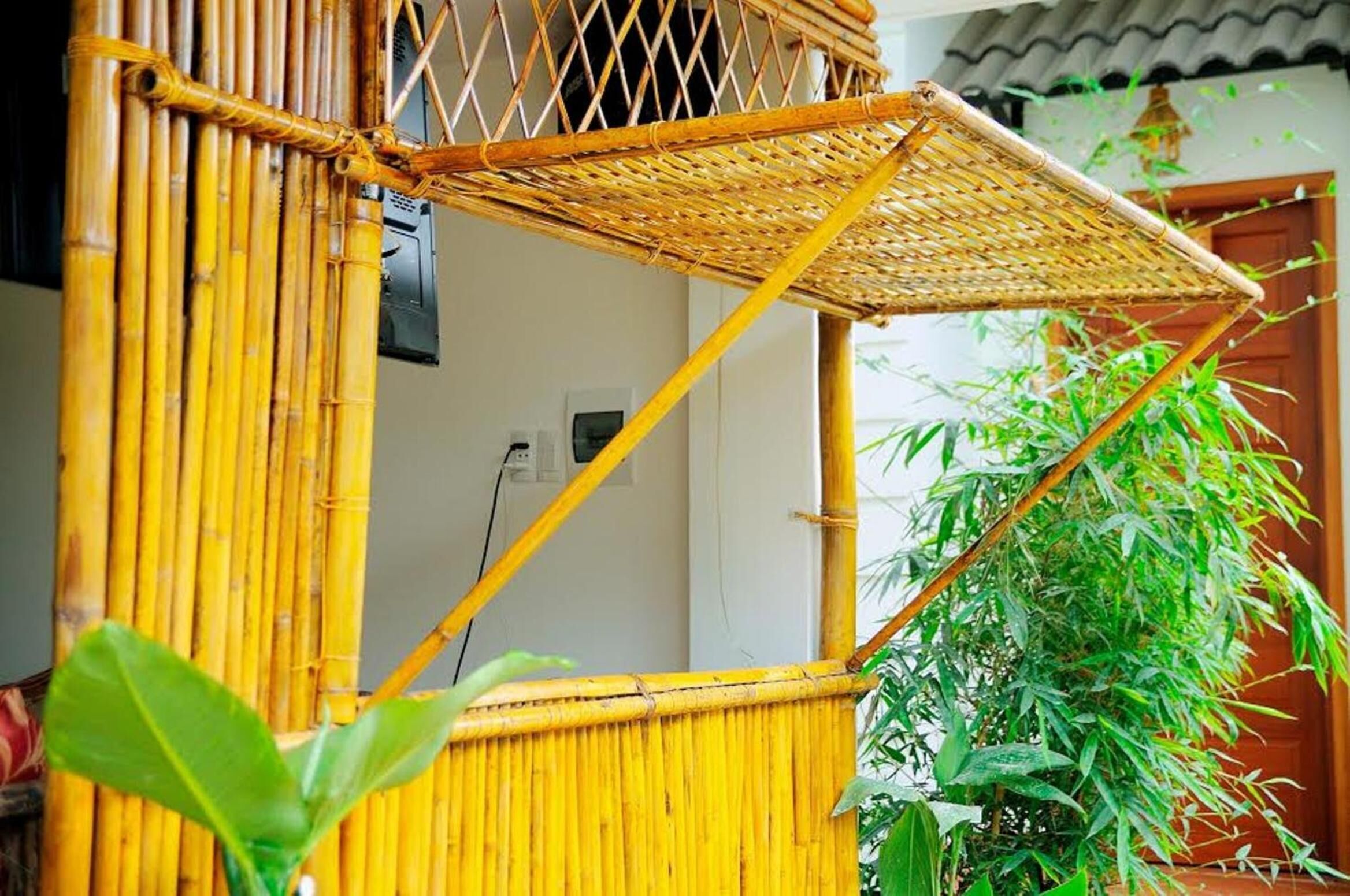 A bamboo structure with a woven roof, likely a part of a building's exterior.