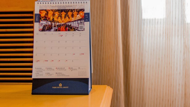 A calendar with a photo of a lantern-lit street, listing countries and dates. - Grand Park Wuxi (Wuxi)